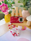 Scarlet – The Statement Maker | Sony Cyber-shot DSC-T100 – Red